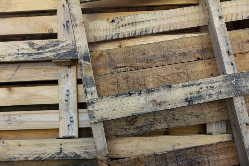 Close-up of worn pallet boards and stringers with nail heads showing
